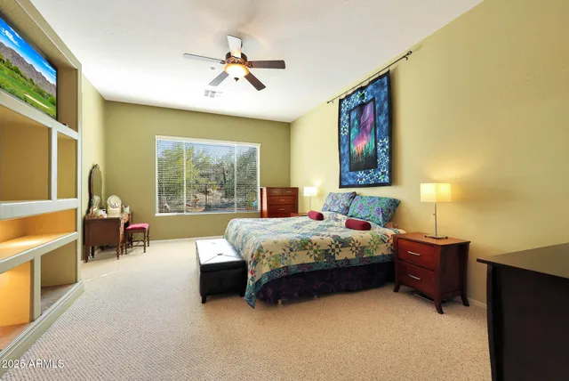 a bedroom with a bed dresser and window