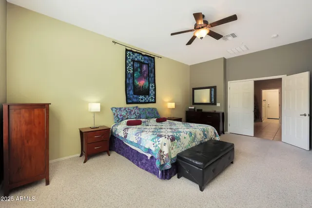 a bedroom with a bed and a chandelier