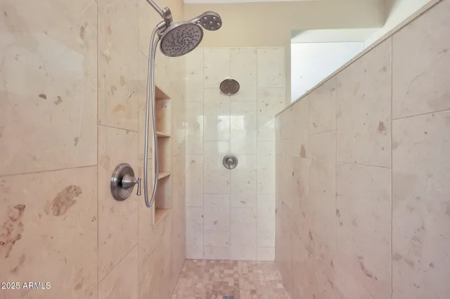 a bathroom with a granite countertop shower and a sink