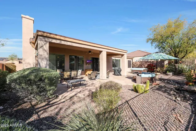 a backyard of a house with barbeque oven and outdoor seating