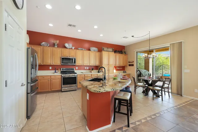 a kitchen with sink cabinets and living room view