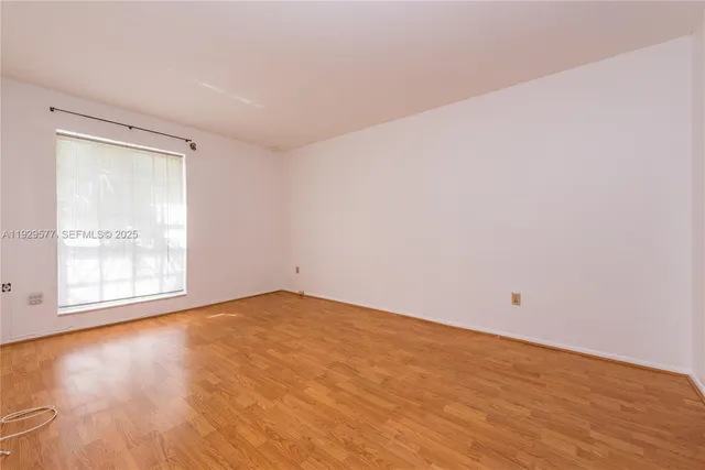a view of an empty room and wooden floor