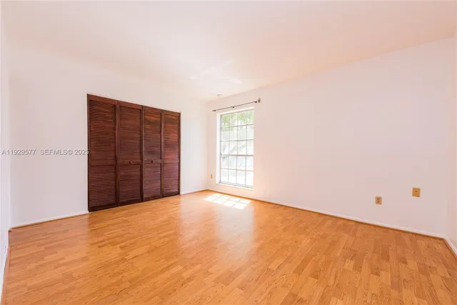 a view of an empty room with closet