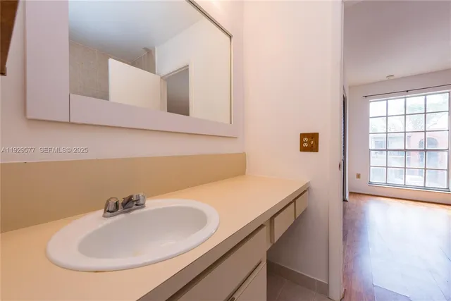 a view of patio with table and chairs under an umbrella