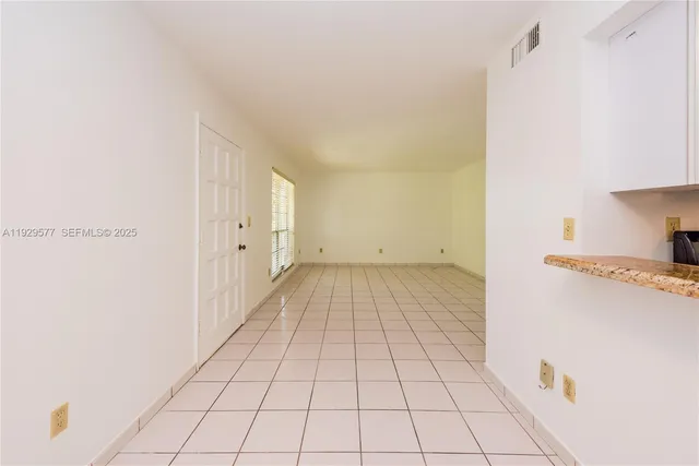 a kitchen with granite countertop a stove and a microwave