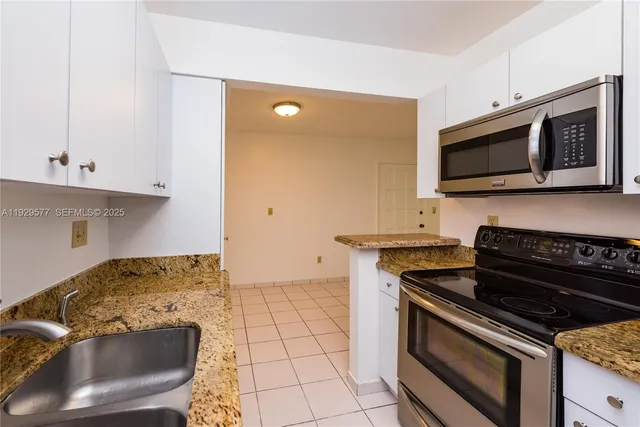 a kitchen with stainless steel appliances a refrigerator and a stove top oven