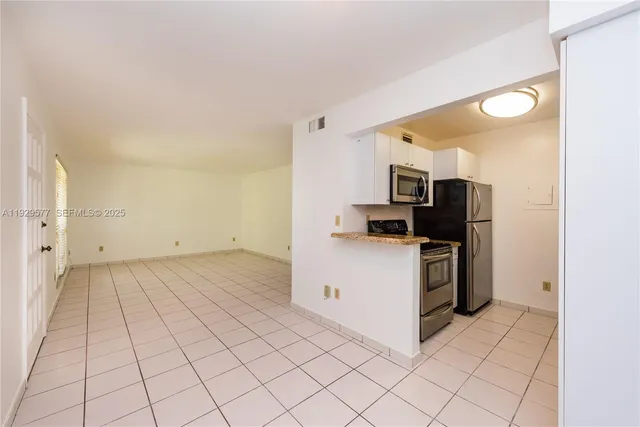 a kitchen with granite countertop a stove and a sink