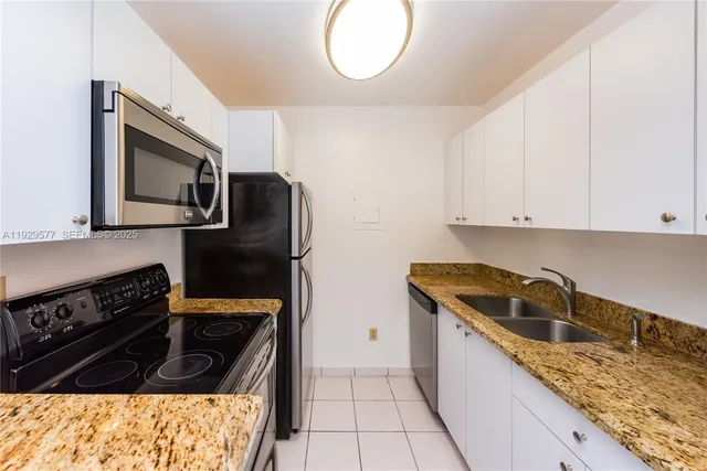 a kitchen with granite countertop a stove and a microwave
