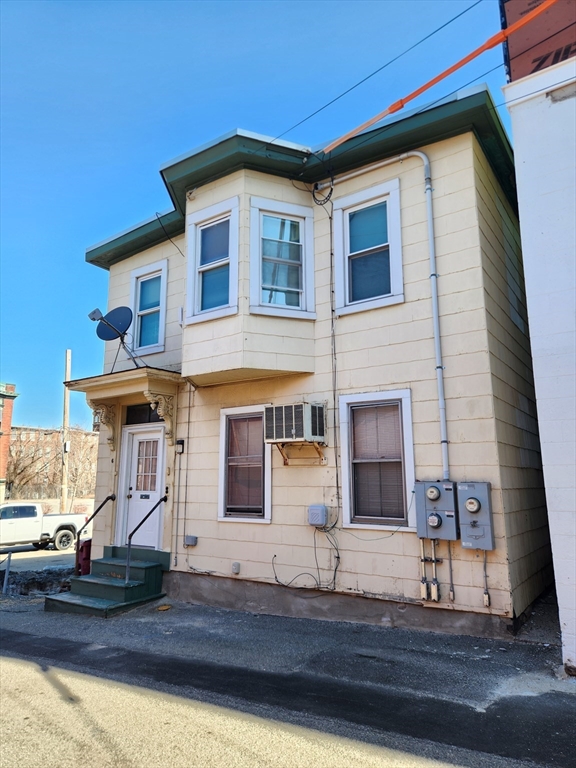 6 McIntyre Street Lowell, MA 01851 - Photo 1 of 12 a front view of a house with yard