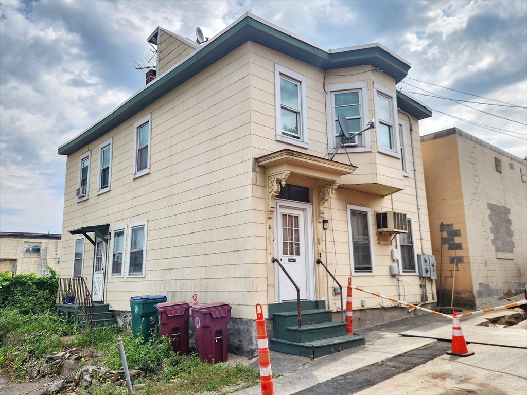 6 McIntyre Street Lowell, MA 01851 - Photo 12 of 12 a front view of a house with a yard