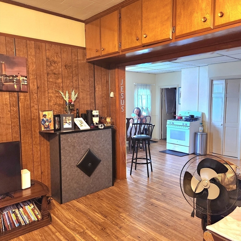 6 McIntyre Street Lowell, MA 01851 - Photo 4 of 12 a living room with furniture a wooden floor and next to a window
