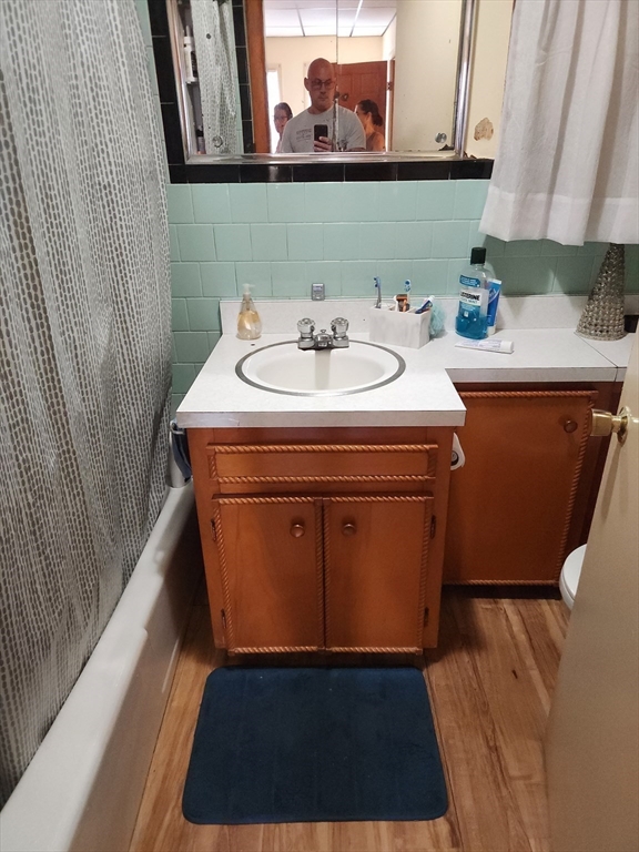 6 McIntyre Street Lowell, MA 01851 - Photo 8 of 12 a bathroom with a sink and a mirror