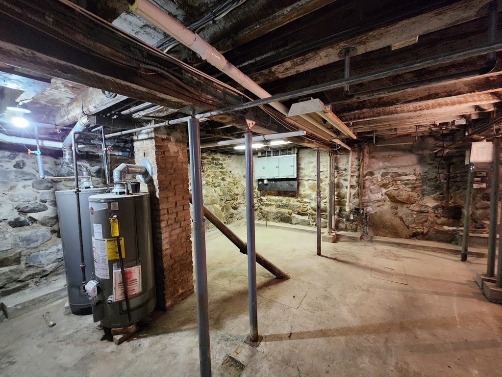6 McIntyre Street Lowell, MA 01851 - Photo 10 of 12 a view of water heater room with wooden walls