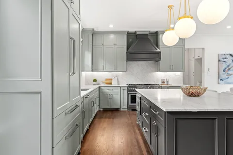 a kitchen with cabinets and stainless steel appliances