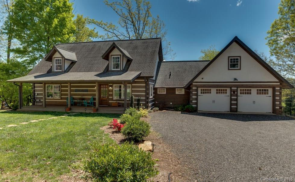 1180 Golf Course Road Tryon, NC 28782 - Photo 1 of 24 a front view of a house with garden