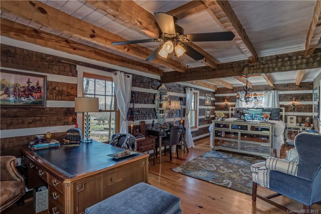 1180 Golf Course Road Tryon, NC 28782 - Photo 11 of 24 a room with lots of wooden furniture and windows