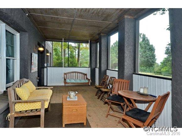 1180 Golf Course Road Tryon, NC 28782 - Photo 16 of 24 a view of a patio with a table chairs and a yard