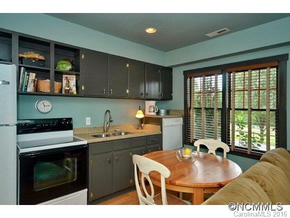 1180 Golf Course Road Tryon, NC 28782 - Photo 19 of 24 a kitchen with a sink cabinets and window