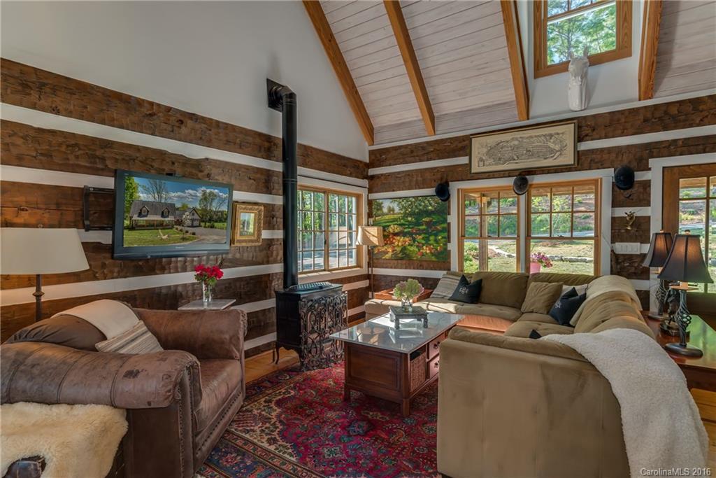 1180 Golf Course Road Tryon, NC 28782 - Photo 4 of 24 a living room with furniture and a floor to ceiling window