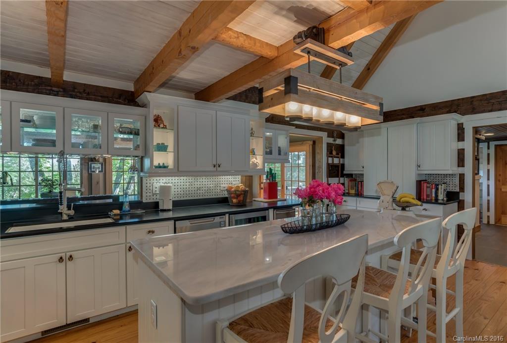 1180 Golf Course Road Tryon, NC 28782 - Photo 6 of 24 a kitchen with stainless steel appliances granite countertop a sink a stove and a wooden cabinets