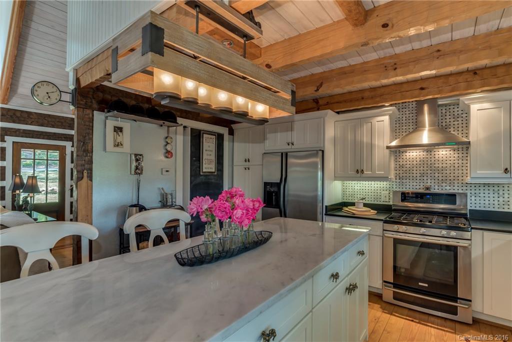 1180 Golf Course Road Tryon, NC 28782 - Photo 7 of 24 a kitchen with a sink and a stove top oven