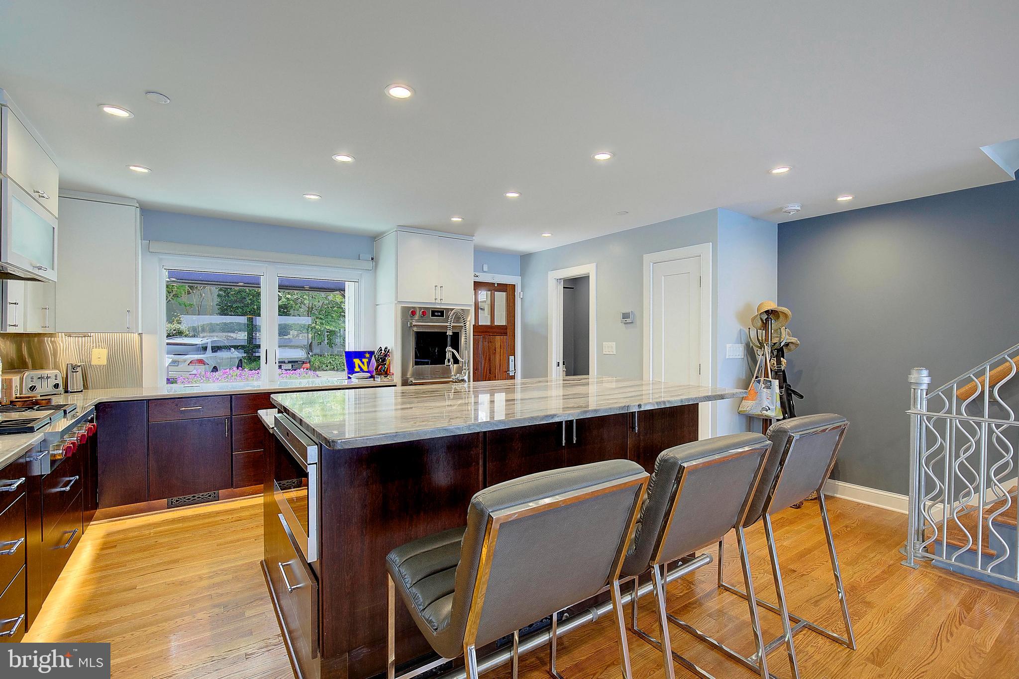 8 Eastern Avenue Annapolis, MD 21403 - Photo 11 of 55 a kitchen with stainless steel appliances granite countertop a table chairs sink and cabinets