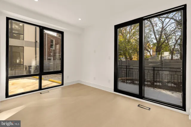 a view of an empty room with sliding glass door