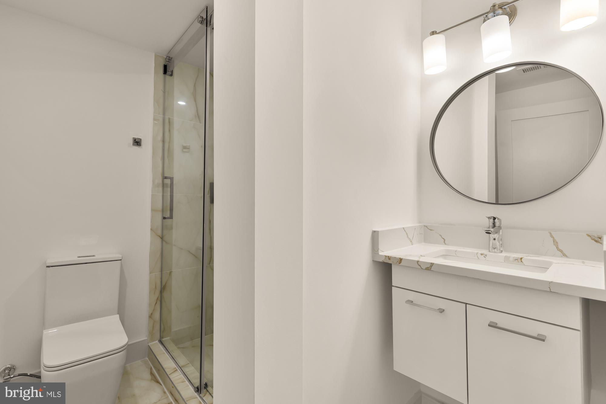 1810 Central Place Northeast, Unit 1 Washington, DC 20002 - Photo 29 of 33 a bathroom with a toilet a sink and mirror
