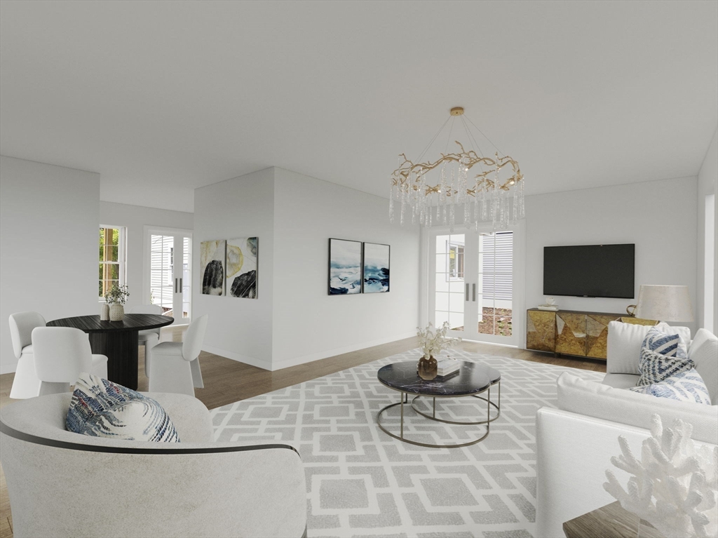 a living room with furniture a flat screen tv and a large window