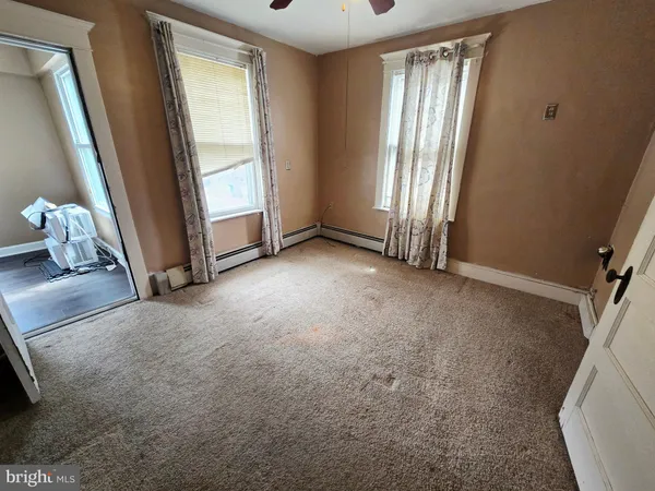 a view of a room with wooden floor and window