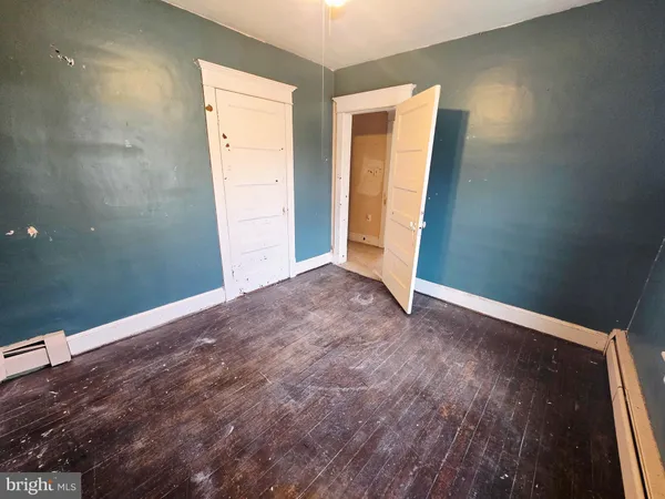 a view of a room with wooden floor and windows
