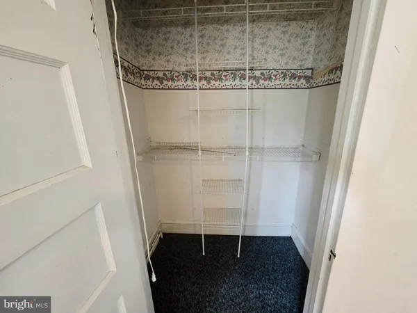 a view of an empty room and wooden floor