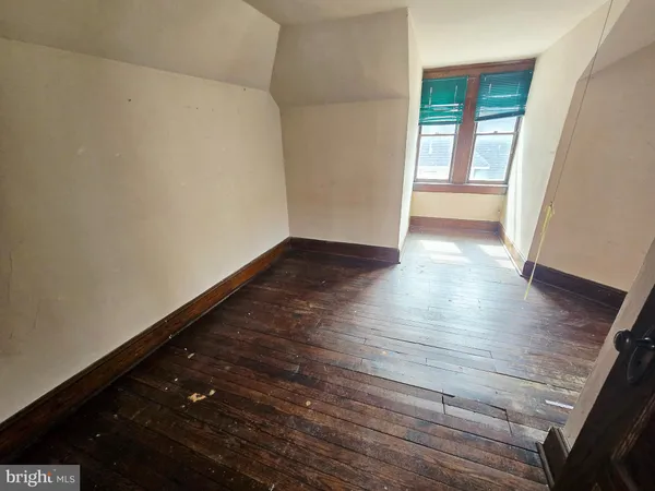 a view of a hallway view with wooden floor and staircase