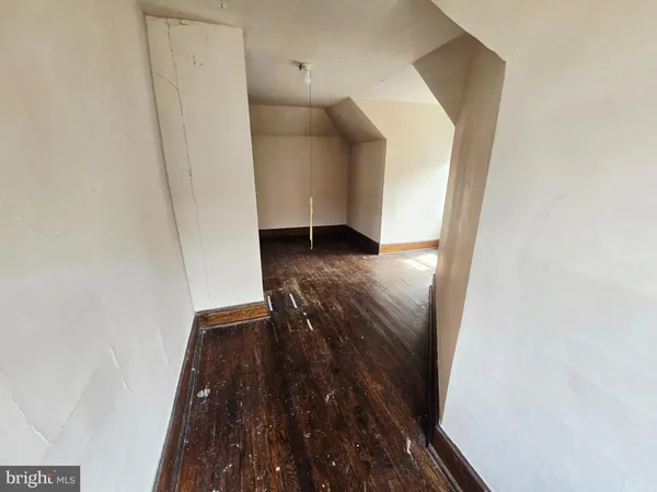a view of water heater room with wooden floor