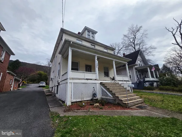 a view of a porch with wooden floor and stairs