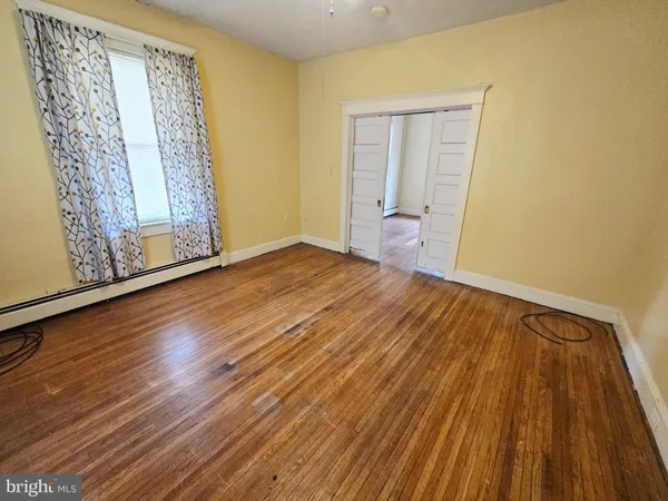 a view of a room with wooden floor and chair