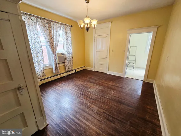 a view of a room with wooden floor and window