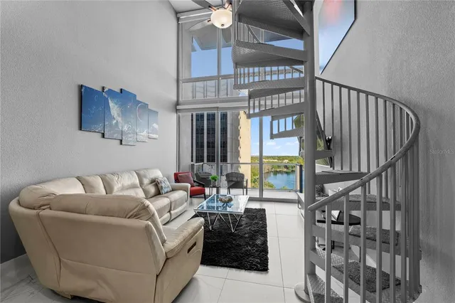 a living room with furniture ceiling fan and a rug