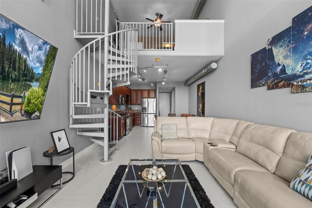 150 East Robinson Street, Unit 1007 Orlando, FL 32801 - Photo 16 of 31 a living room with furniture and a flat screen tv