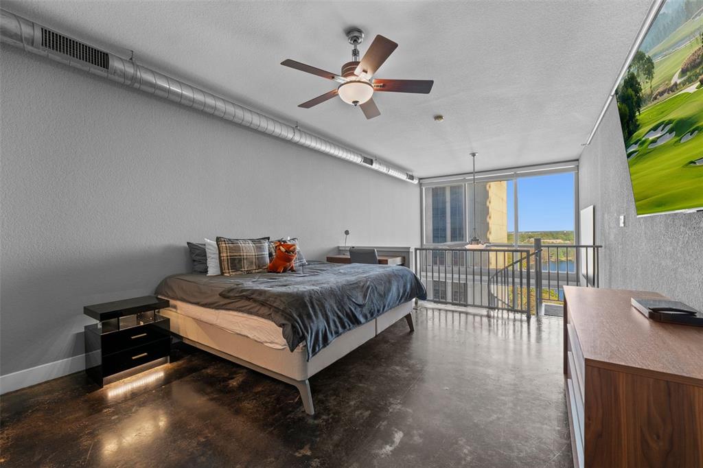 150 East Robinson Street, Unit 1007 Orlando, FL 32801 - Photo 20 of 31 a bed room with a bed and a television