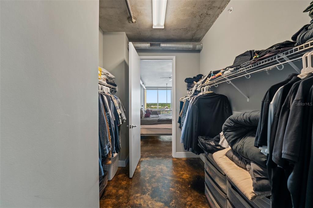150 East Robinson Street, Unit 1007 Orlando, FL 32801 - Photo 23 of 31 a view of walk in closet with clothes and shoes