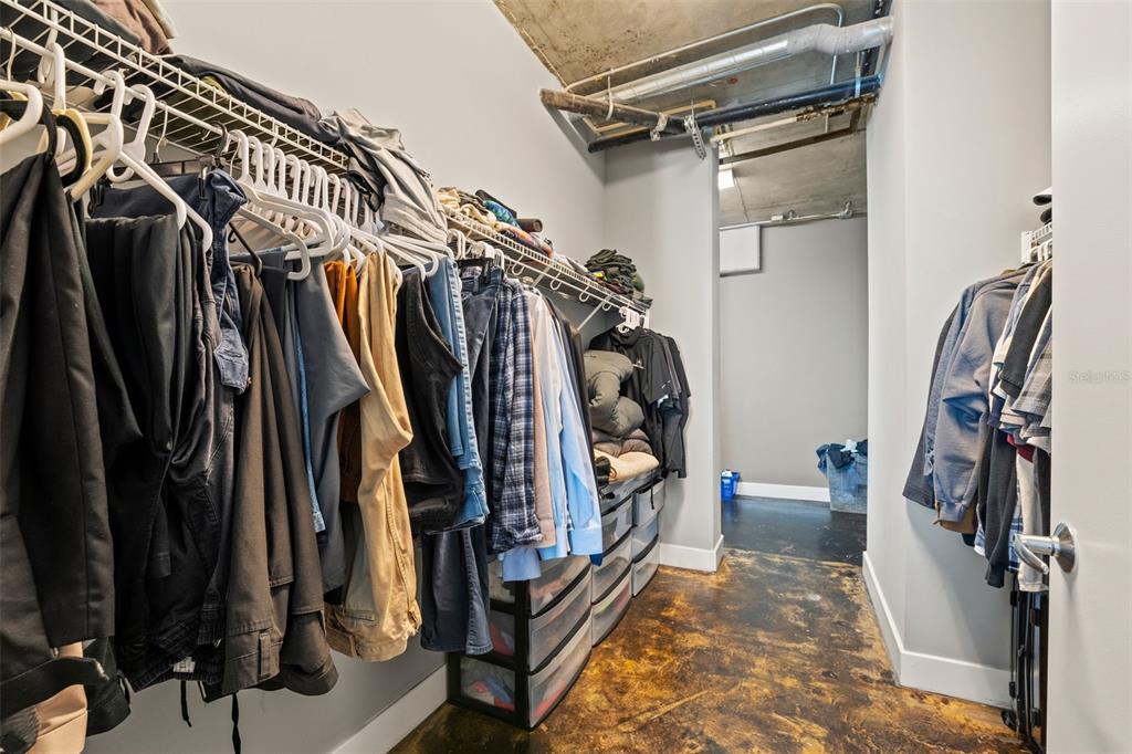 150 East Robinson Street, Unit 1007 Orlando, FL 32801 - Photo 24 of 31 a view of walk in closet with clothes and shoes