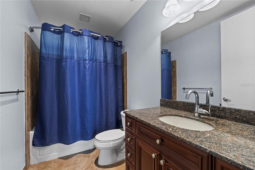 150 East Robinson Street, Unit 1007 Orlando, FL 32801 - Photo 25 of 31 a bathroom with a granite countertop sink toilet and shower