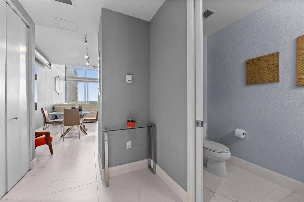 150 East Robinson Street, Unit 1007 Orlando, FL 32801 - Photo 6 of 31 a bathroom with a toilet tub and shower