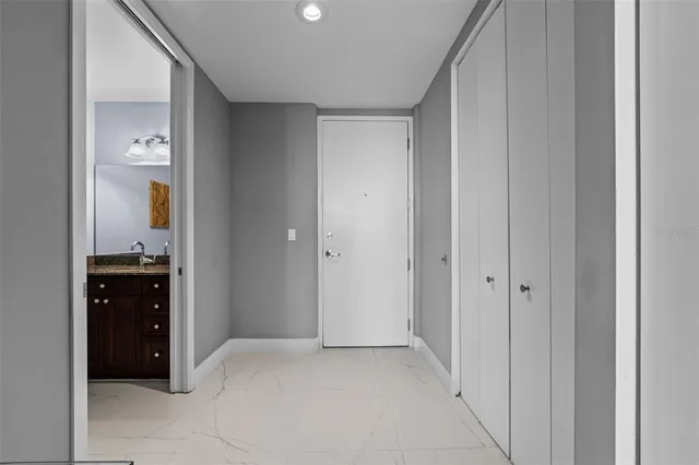 a kitchen with stainless steel appliances granite countertop a stove top oven a sink and a refrigerator