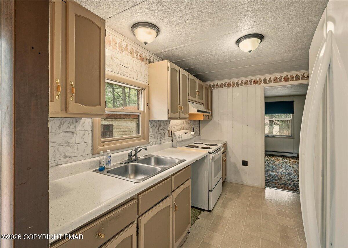 3416 Walnut Road Gilbert, PA 18331 - Photo 13 of 27 a kitchen that has a sink and a stove in it