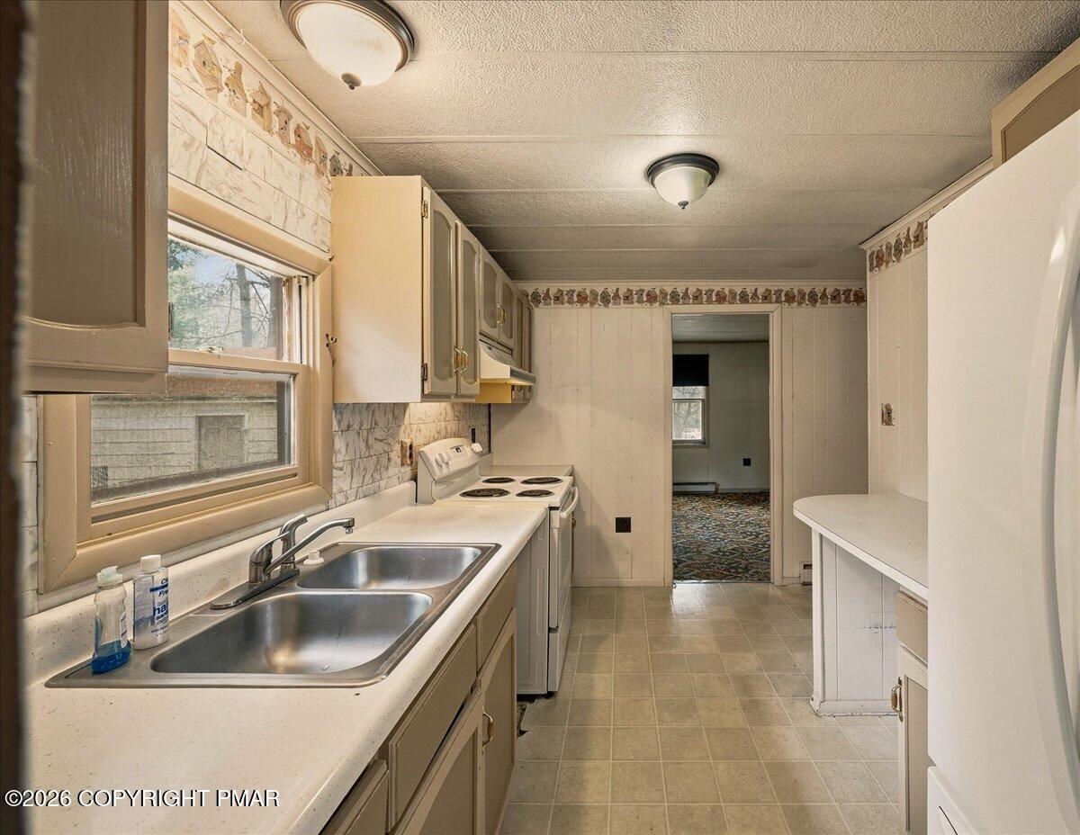 3416 Walnut Road Gilbert, PA 18331 - Photo 14 of 27 a kitchen with a sink appliances and cabinets