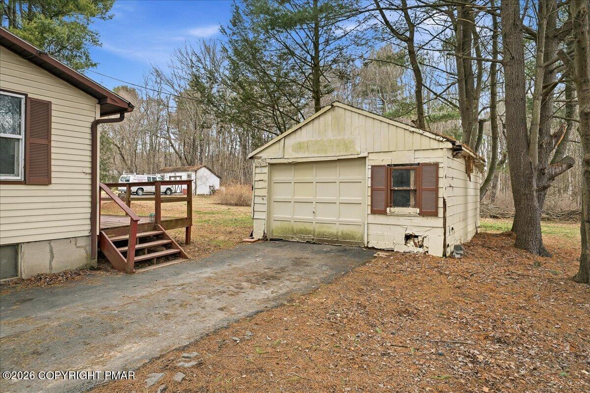 3416 Walnut Road Gilbert, PA 18331 - Photo 2 of 27 a view of a house with a yard and wooden fence