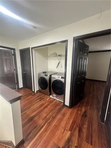 a bedroom with a bed and a large mirror in closet