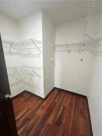 a view of a room with wooden floor